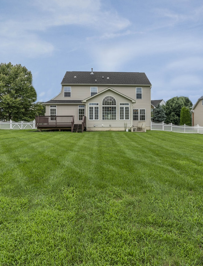 Freshly-mowed lawn in front of a house cared for by Birch's Lawn Services
